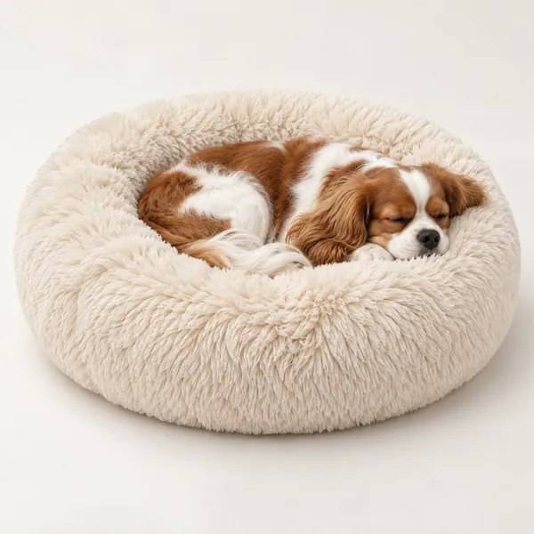 Small dog curled up in a plush calming donut bed